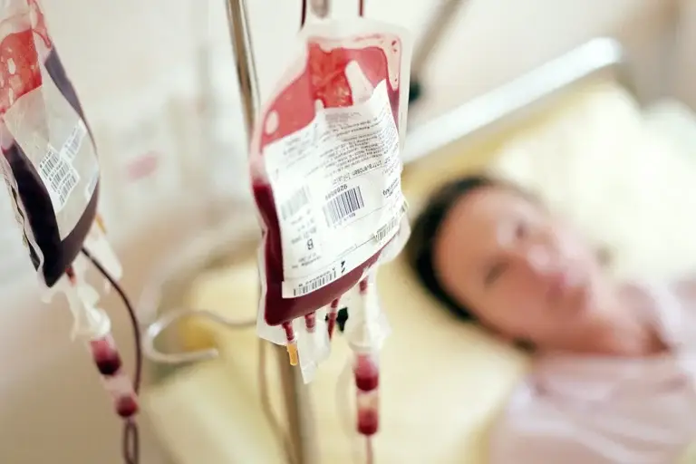 Patient being monitored during IV iron infusion for possible side effects
